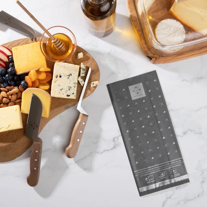 A box of FORMATICUM - REUSABLE CHEESE STORAGE BAGS by FORMATICUM features a white and black design, “Reduce cheese waste” and “Keeps cheese fresher, longer” text, and contains 10 reusable bags.