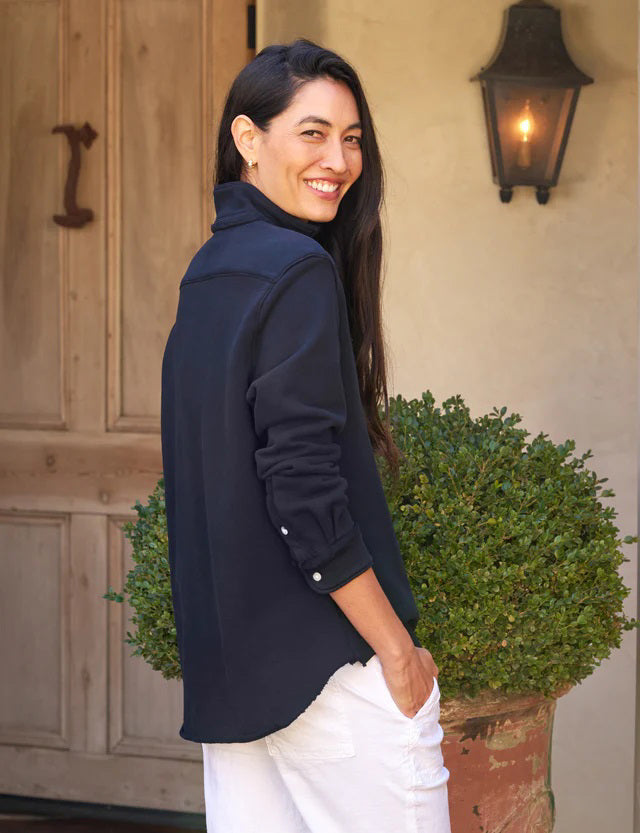 The FRANK & EILEEN Eileen Relaxed Button Up in Triple Fleece British Royal Navy showcases bust-flattering button placement, long rolled-up sleeves, and a chest pocket. Set against a light textured background, it offers classic style and ultimate comfort.