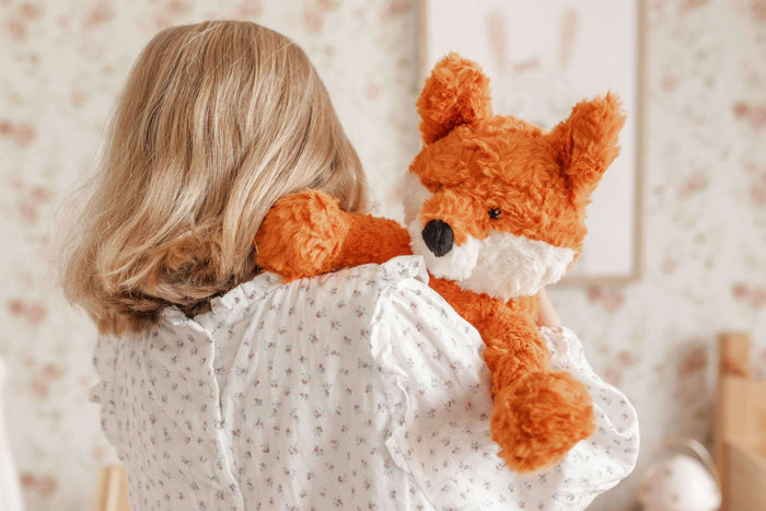 Child hugging Frankl The Weighted Fox teddy, a soft plush toy designed for comfort and emotional wellbeing.