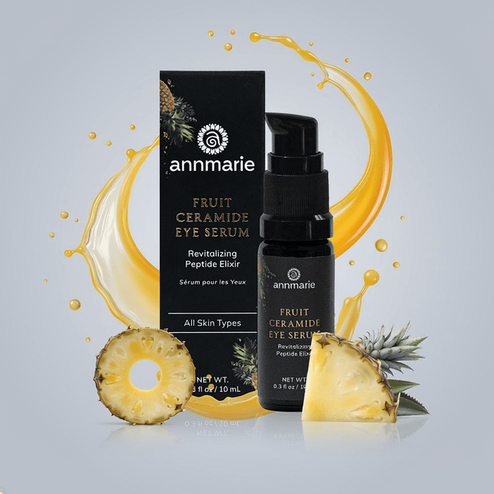 Annmarie Fruit Ceramide Eye Serum with packaging and pineapple slices on a gray background
