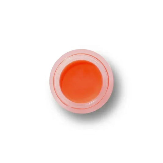 Small container of orange cream on a white background