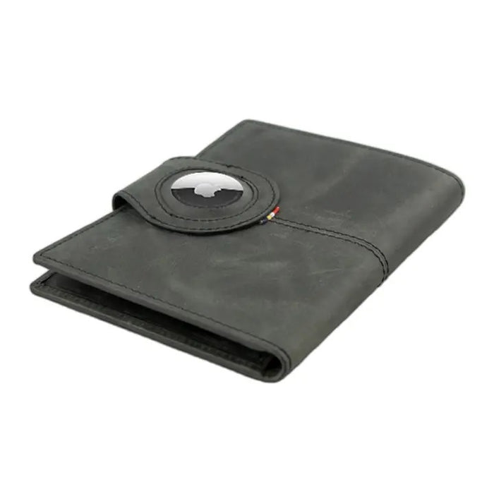 The GARZINI RFID-blocking leather passport holder in black features an AirTag compartment and snap button closure, shown on a white background.