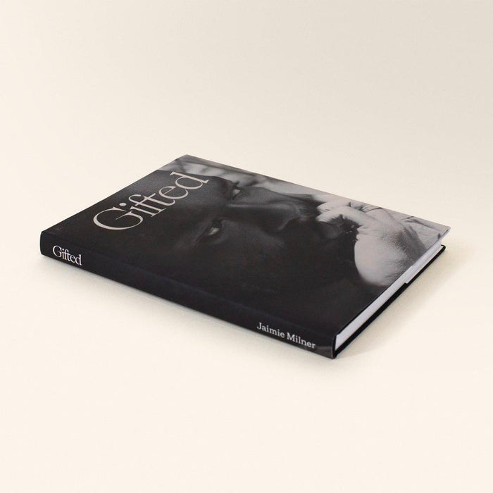 Side view of the Gifted book with the title on the spine and a black and white image on the cover
