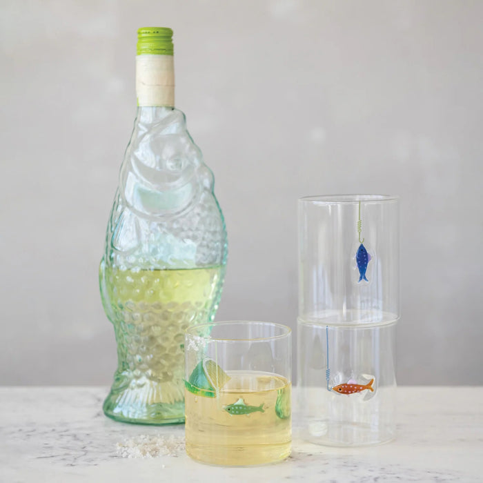 Set of three CREATIVE COOP HAND-BLOWN DRINKING GLASS WITH FISH ON HOOK, each with a unique green, blue, or red fish design—perfect for adding a playful accent to any coastal décor.