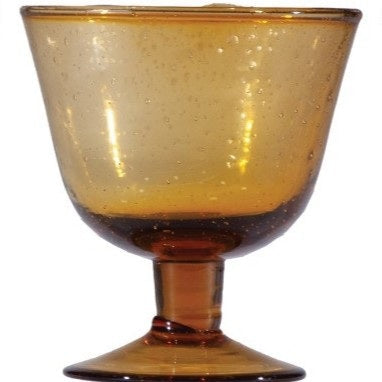 Four CREATIVE COOP HAND-BLOWN STEMMED SEEDED GLASSES in blue, amber, light green, and dark blue are displayed side by side on a white background, highlighting the charm of traditional glassmaking.