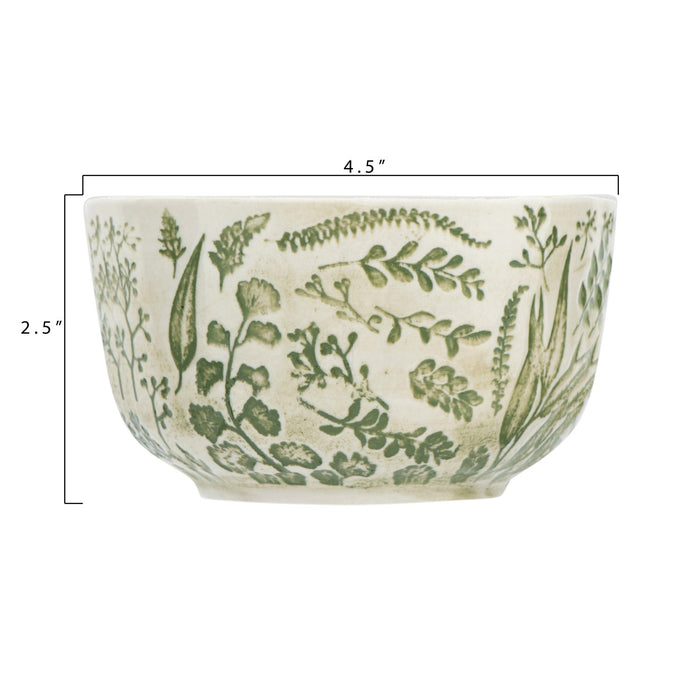 The HAND-STAMPED STONEWARE BOWL WITH BOTANICAL PATTERN by CREATIVE COOP features green leaf and fern illustrations encircling its white ceramic exterior, offering an artisan-inspired look.