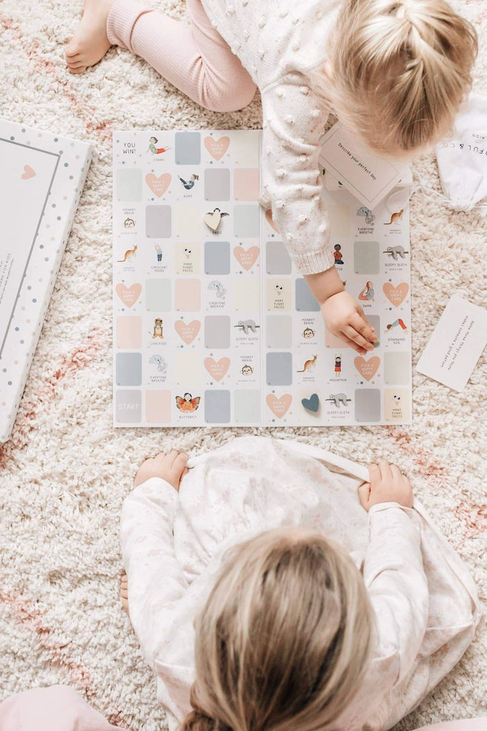Two children playing with a colorful puzzle on a carpeted floor.
