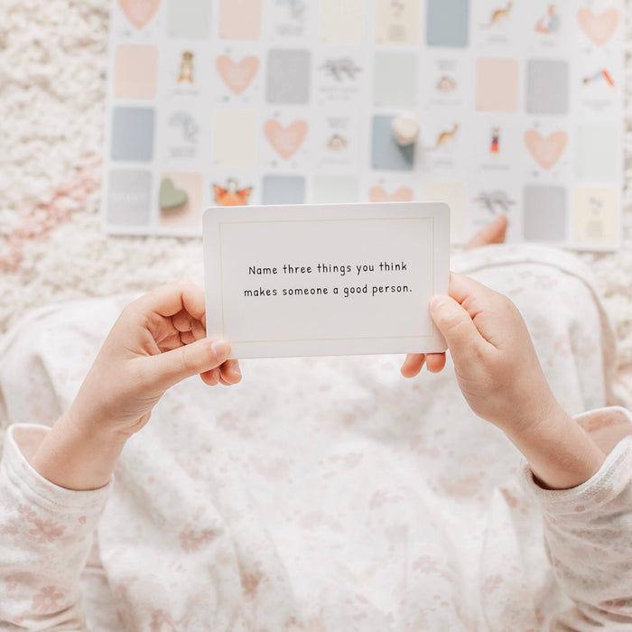 Person holding a card with text in front of a patterned background