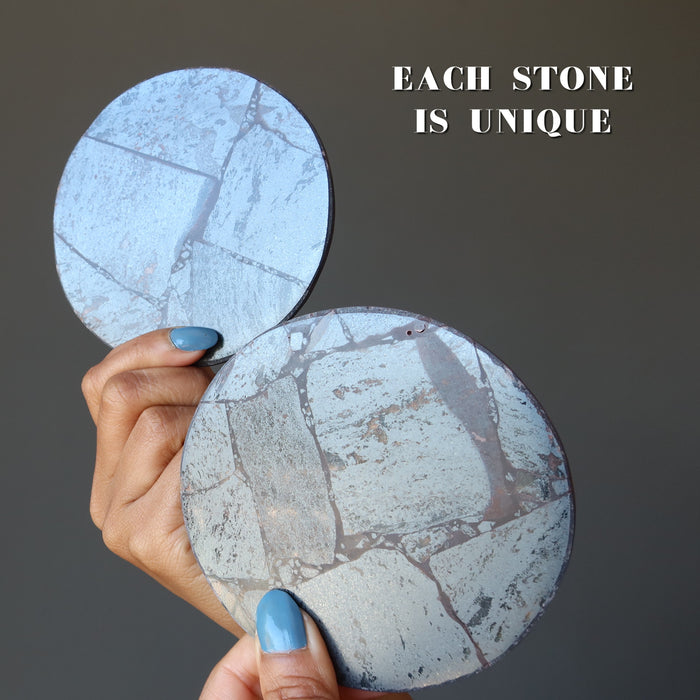 two hematite circle coasters to show each is unique