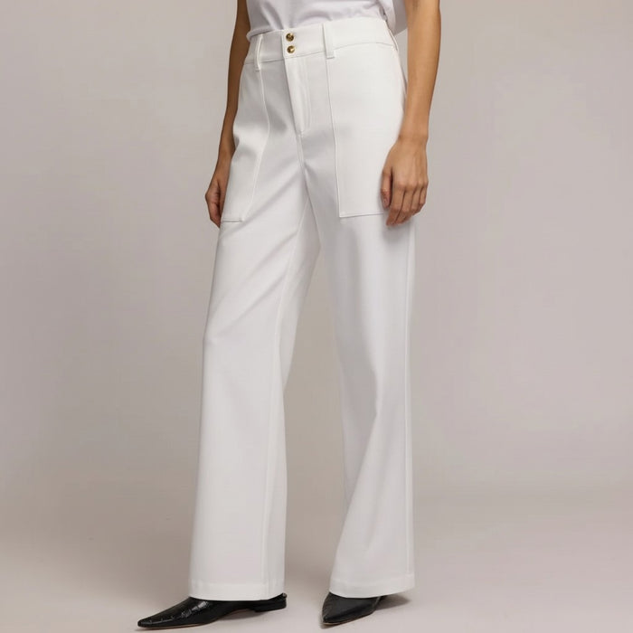 A person models the HINSON WU KELLY TRAVELERS TWILL PANT IN WHITE, featuring high-waisted, wide-leg stretch twill with large front pockets and double button closure—ideal travel-friendly style from HINSON WU.