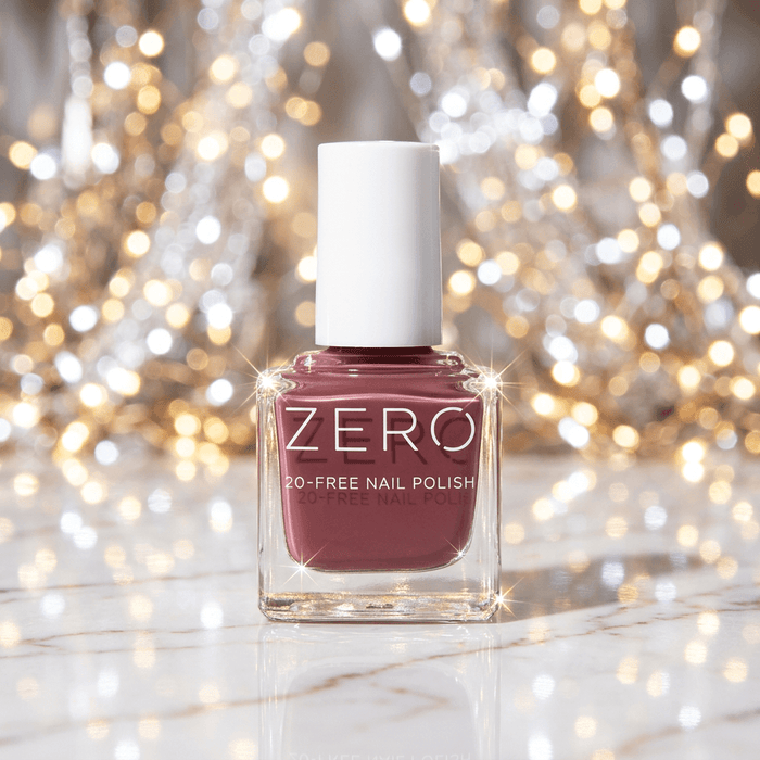 Nail polish bottle with 'ZERO' branding against a sparkling background