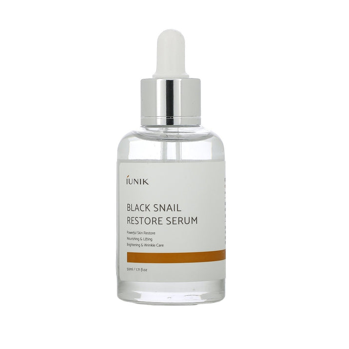 IUNIK Black Snail Restore Serum is a nourishing serum enriched with Snail Extract and Centella Asiatica Leaf Water to repair and rejuvenate the skin. Its hydrating formula helps improve elasticity, reduce redness, and promote a smoother, more radiant complexion. Infused with botanical extracts like Green Tea, Chamomile, and Rosemary, it soothes and calms irritation while providing antioxidant benefits. Ideal for all skin types, this serum supports skin recovery and leaves it feeling refreshed an