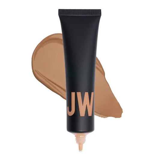 A black tube labeled "JW" stands before a beige swatch, highlighting JASON WU BEAUTY's TINTED MOISTURIZER MEETS CC CREAM for a natural glow on a white background.