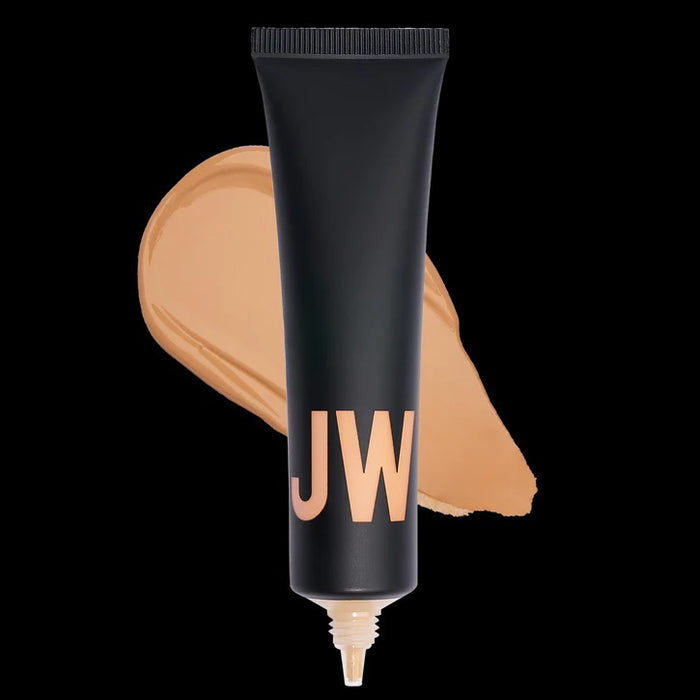 A black tube labeled "JW" stands before a beige swatch, highlighting JASON WU BEAUTY's TINTED MOISTURIZER MEETS CC CREAM for a natural glow on a white background.
