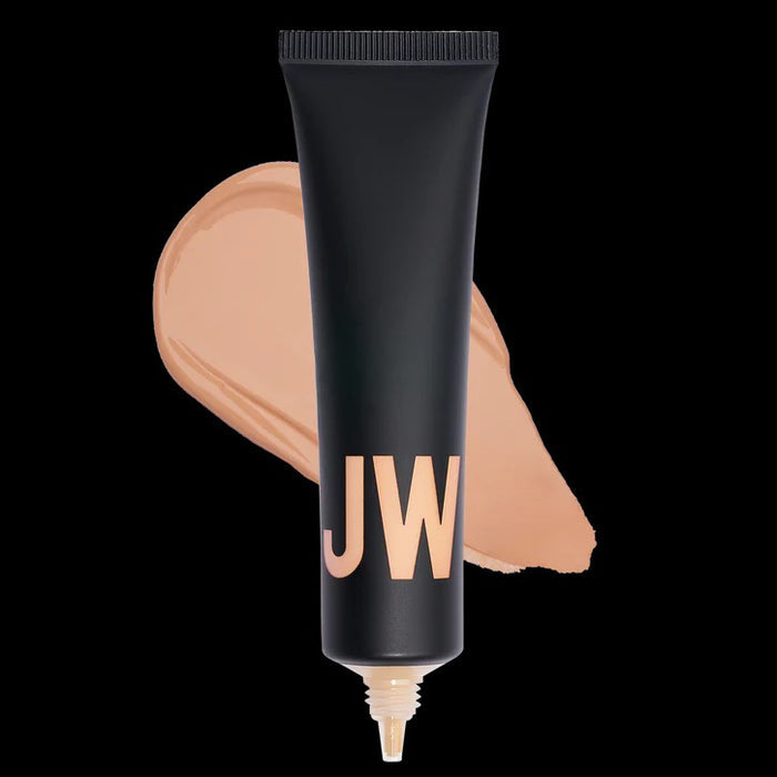 A black tube labeled "JW" stands before a beige swatch, highlighting JASON WU BEAUTY's TINTED MOISTURIZER MEETS CC CREAM for a natural glow on a white background.