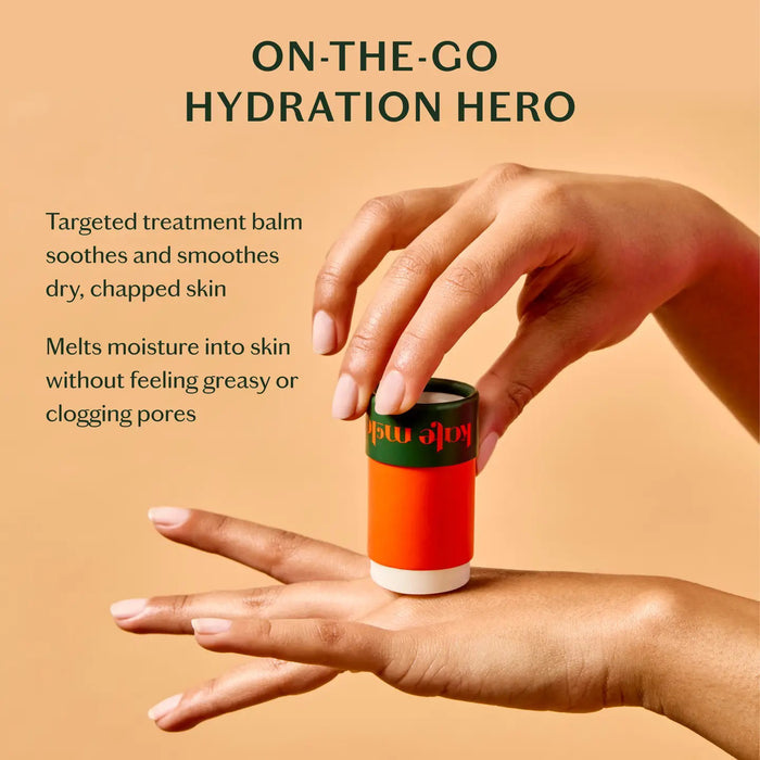 A cylindrical skincare stick features an orange design with "KATE MCLEOD" inscribed. Next to it, a green cap displays "The Everywhere Stick" in white. A red circle above says "New In." Made with pure plant butters, this wax-free formula is a hydration hero, all set against a light green background.