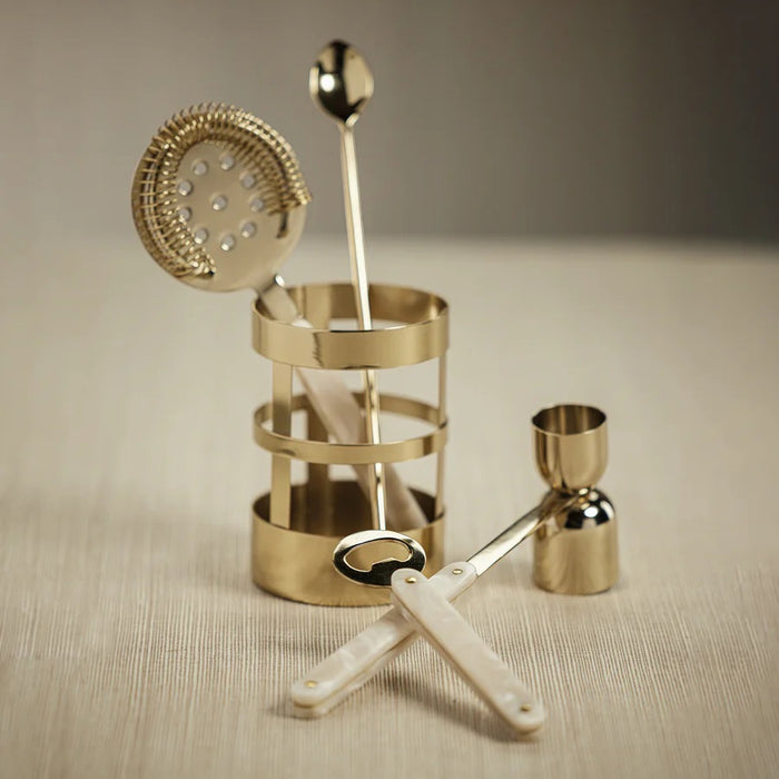 The KNIGHTSBRIDGE 5-PIECE BAR SET IN GOLD by ZODAX includes a strainer, jigger, bar spoon, and bottle opener with pearlescent handles—all in metallic gold—perfect for your cocktail hour. Elegantly displayed on a white background.
