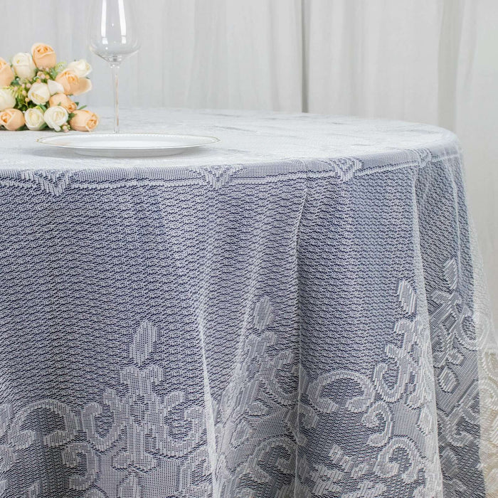Elegant lace tablecloth with intricate detailing on a round table.
