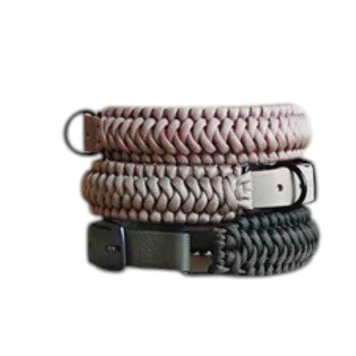 Two LAMBWOLF COLLECTIVE New Jupiter Collars in Moon, size Medium—one in light beige and the other in dark gray—are stacked on a light wooden cabinet against a plain light background. Each collar blends contemporary style with cushioned comfort for your pup.