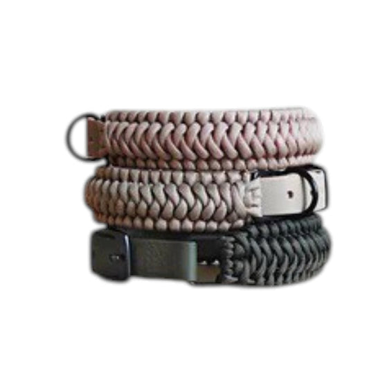 Two LAMBWOLF COLLECTIVE NEW JUPITER Dog Collars in small, one in beige and one in gray, are stacked on a light wooden surface against a plain, light-colored wall. Designed by LAMBWOLF COLLECTIVE, each collar combines cushioned comfort with sturdy durability, making them perfect for everyday wear.