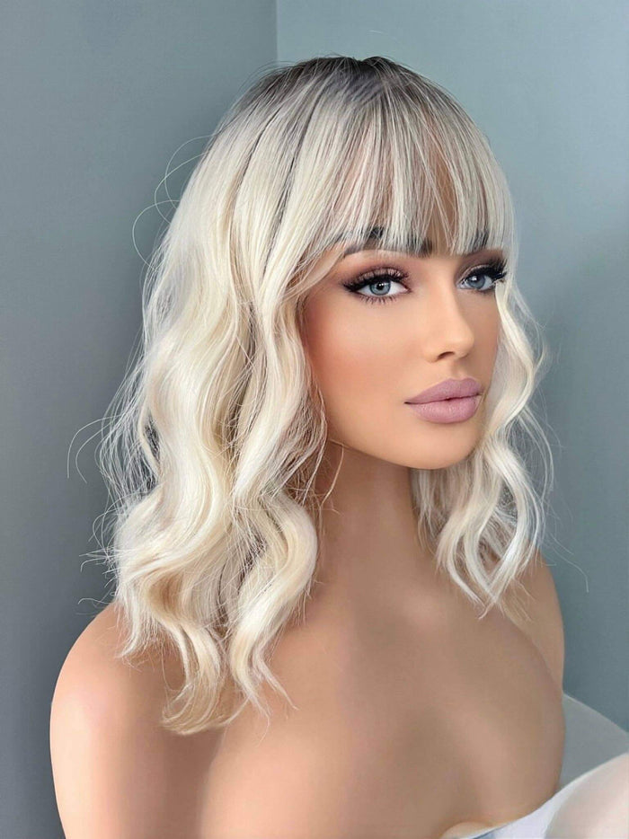 Lilah Short White Blonde Body Wave Wig with Bangs, featuring soft waves and light bangs, perfect for everyday style.