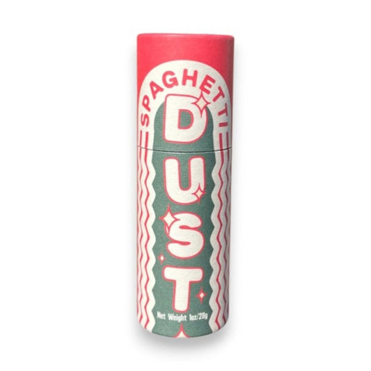 A cylindrical container of L'ISOLINA PASTA - SPAGHETTI DUST from L’ISOLINA PASTA stands upright, with a small pile of colorful Italian pasta spice flakes nearby on a light background.