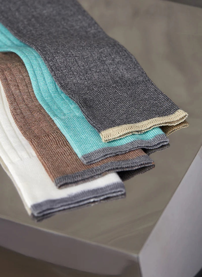 The LORENZO UOMO Ribbed Mercerized Cotton Sock in taupe is displayed upright against a light background. Made in Italy, this luxury sock is crafted from fine Egyptian cotton and finished with a dark contrast band at the top.