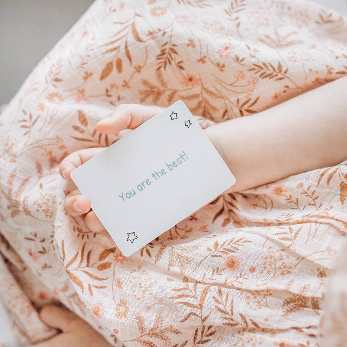 Child holding a positive affirmation card from Love Notes - Mindful and Co Kids, featuring the text 'You are the best!'