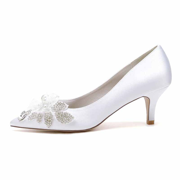 pearl embellished wedding shoes in white satin with floral details and a graceful heel