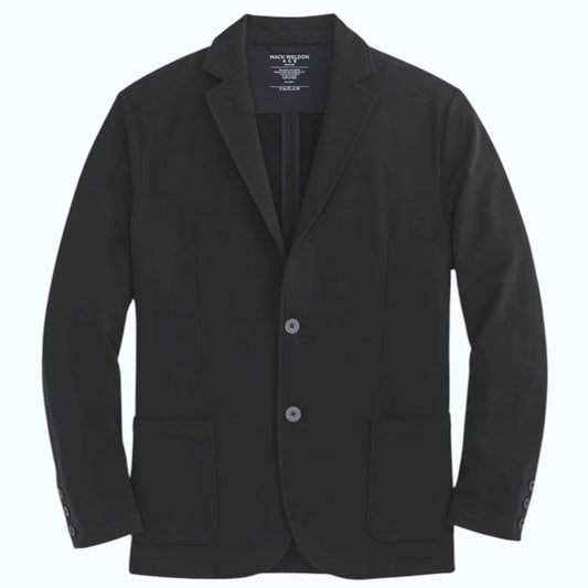 A person in a navy shirt holds open the MACK WELDON ACE BLAZER IN TRUE BLACK, revealing its comfortable, machine-washable design with an inside pocket and inner lining.