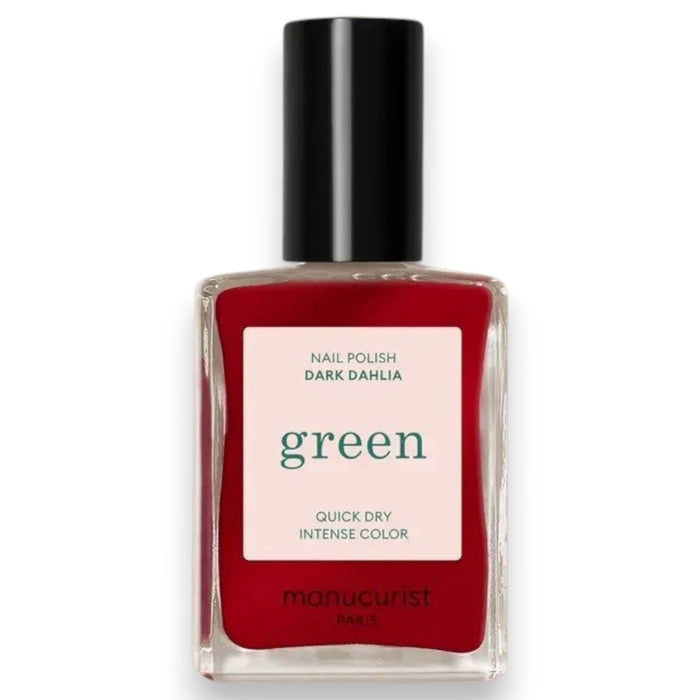 A hand with neatly manicured nails painted in MANUCURIST - GREEN™ NAIL POLISH IN DARK DAHLIA by MANUCURIST INC rests on a light pink, long-sleeve garment. The lighting highlights the glossy finish of the nail polish.
