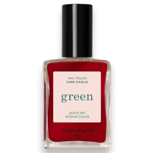 A hand with neatly manicured nails painted in MANUCURIST - GREEN™ NAIL POLISH IN DARK DAHLIA by MANUCURIST INC rests on a light pink, long-sleeve garment. The lighting highlights the glossy finish of the nail polish.