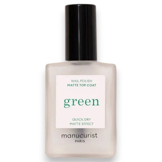 A hand with light blue painted nails holds a bottle of MANUCURIST - GREEN™ Nail Polish Matte Top Coat by MANUCURIST INC, featuring a black cap and clear plant-based formula, against a beige background.
