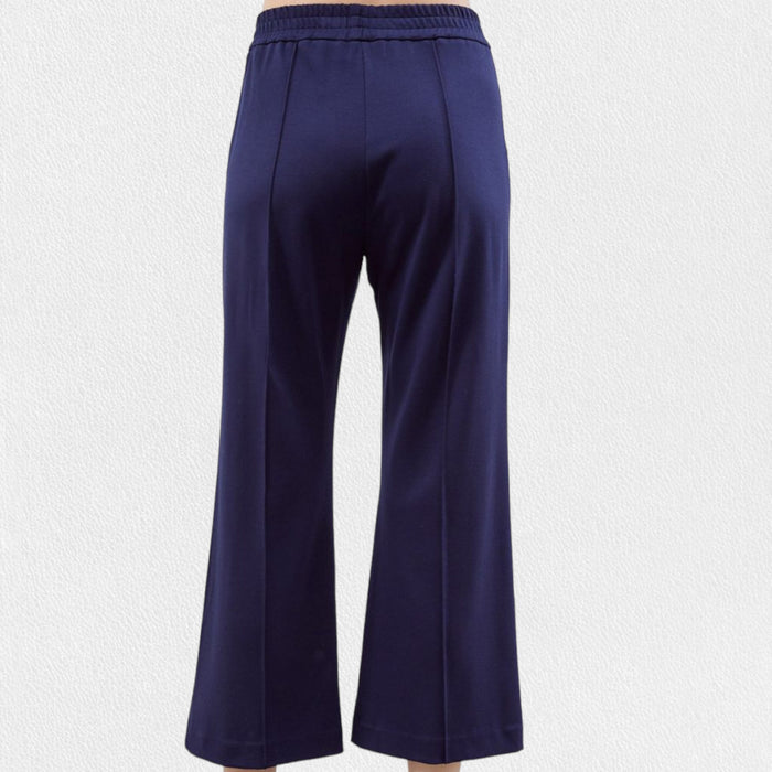 A person wears MEIMEIJ Pull-On Straight Leg Cropped Pants—black, high-waisted with an elastic waistband and subtle front seam—standing against a plain white background.