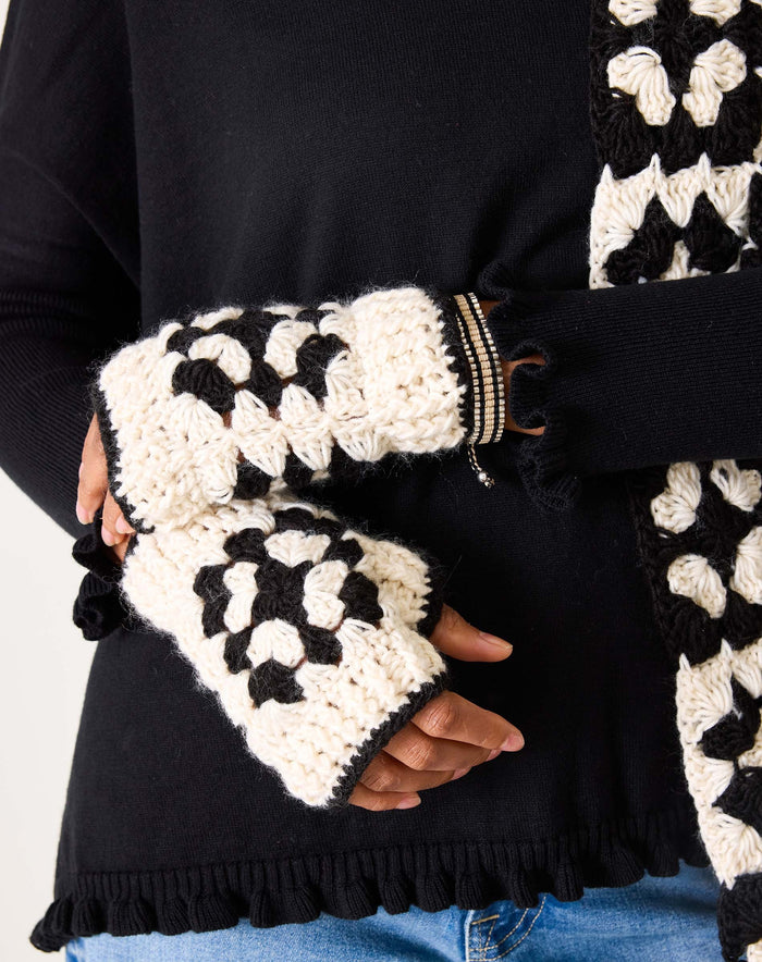 The MERSEA - LA PAZ CROCHET FINGERLESS GLOVES by MERSEA, cream-colored with black borders and a central black geometric pattern, are displayed on a white background.