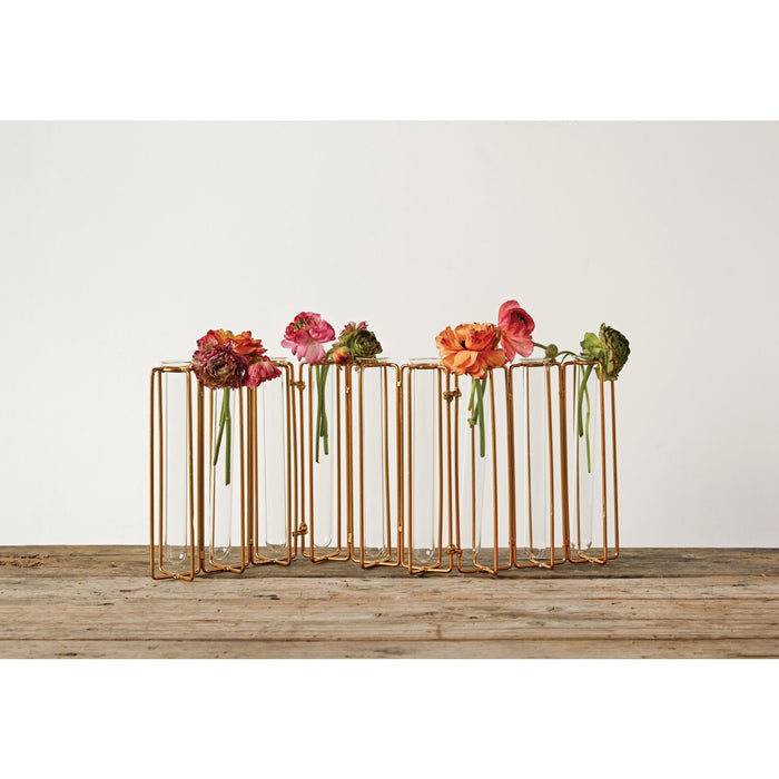 The METAL AND GLASS JOINTED VASE WITH 9 TEST TUBES by CREATIVE COOP features clear tubes in a gold metal stand, perfect for displaying green leafy stems and adding an elegant touch to your home décor.