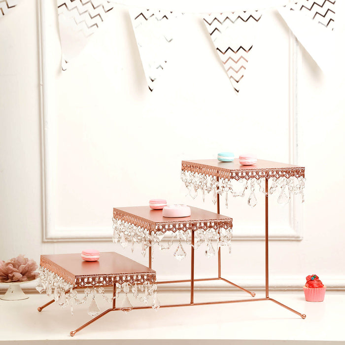 Elegant tiered dessert stand with crystal accents and pink macarons.