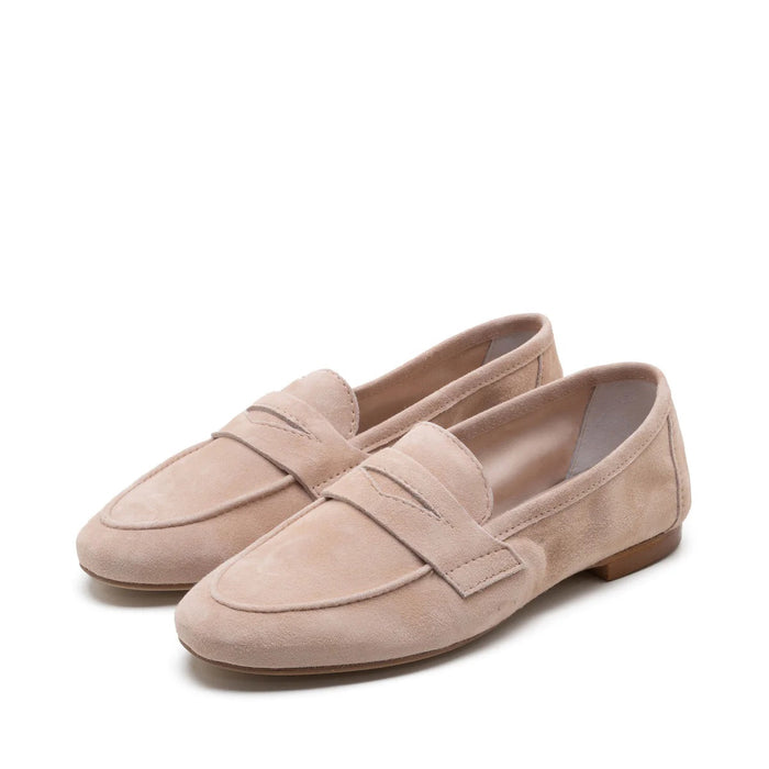 The MICHELE LOPRIORE - PAOLA SUEDE LOAFER is a light brown suede moccasin loafer with a low heel and decorative strap, displayed against a plain white textured background.