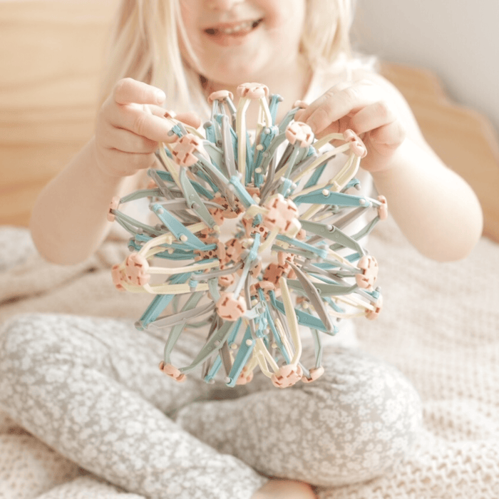 Child enjoying the Mindfulness Magic Ball, an interactive toy for mindful breathing and relaxation techniques.