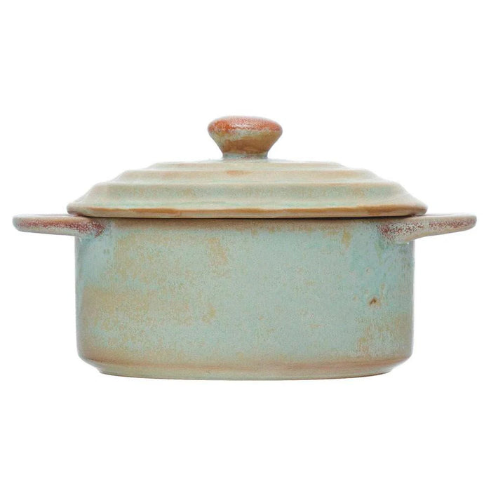 Introducing the MINI STONEWARE BAKER WITH LID by CREATIVE COOP—a rustic, round ceramic pot with side handles and a matching lid. Crafted in striking blue-green and brown hues, this mini baker features a reactive crackle glaze for distinctive texture. The lid is topped with an easy-to-grip knob handle, making it ideal for serving individual casseroles in style.