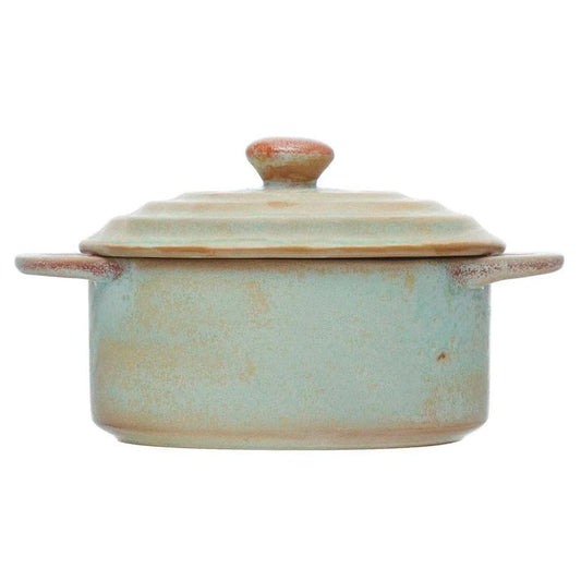 Introducing the MINI STONEWARE BAKER WITH LID by CREATIVE COOP—a rustic, round ceramic pot with side handles and a matching lid. Crafted in striking blue-green and brown hues, this mini baker features a reactive crackle glaze for distinctive texture. The lid is topped with an easy-to-grip knob handle, making it ideal for serving individual casseroles in style.