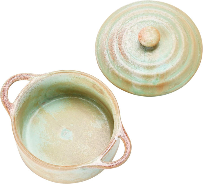 Introducing the MINI STONEWARE BAKER WITH LID by CREATIVE COOP—a rustic, round ceramic pot with side handles and a matching lid. Crafted in striking blue-green and brown hues, this mini baker features a reactive crackle glaze for distinctive texture. The lid is topped with an easy-to-grip knob handle, making it ideal for serving individual casseroles in style.