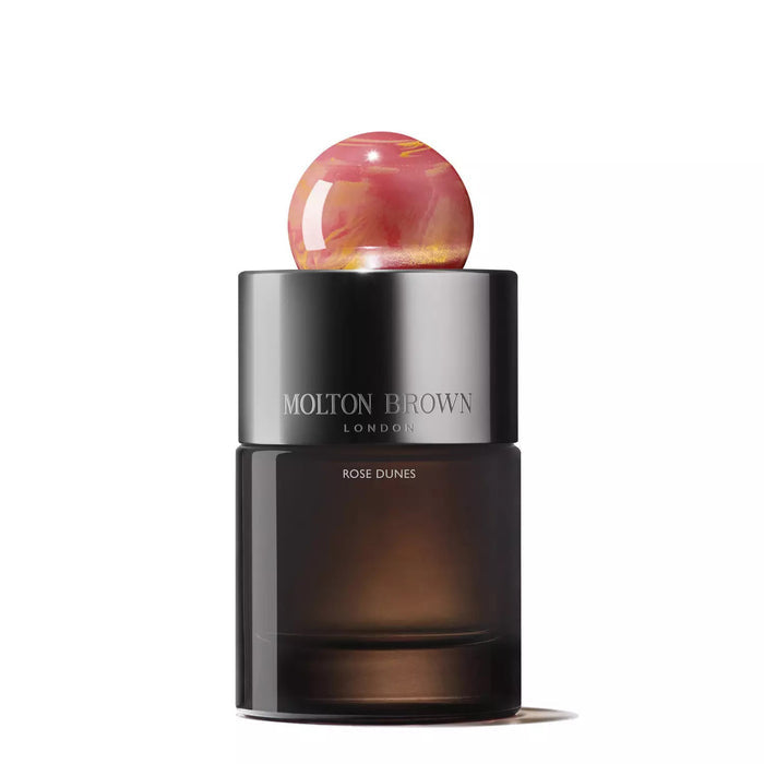 MOLTON BROWN - ROSE DUNES EAU DE PARFUM is a luxurious fragrance with opulent oudh, housed in a bottle topped with a distinctive round ball.