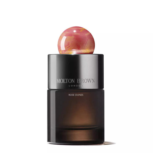 MOLTON BROWN - ROSE DUNES EAU DE PARFUM is a luxurious fragrance with opulent oudh, housed in a bottle topped with a distinctive round ball.