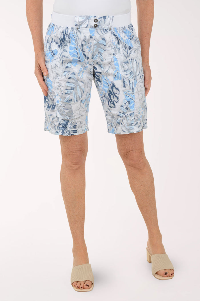 Person wearing blue floral shorts on a white background