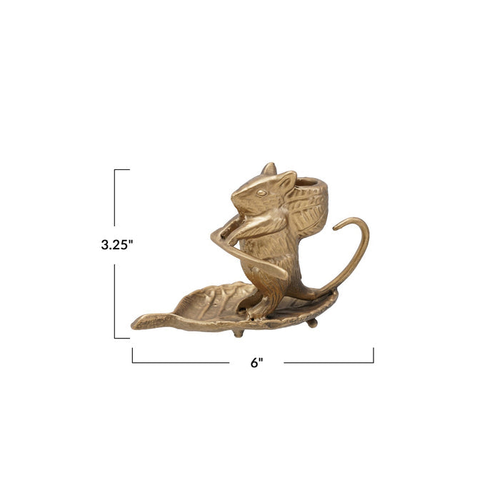 The CREATIVE COOP MOUSE ON LEAF CAST METAL TAPER HOLDER in an antique gold finish features a mouse standing on a leaf, holding a smaller leaf, with a taper candle holder on its back.
