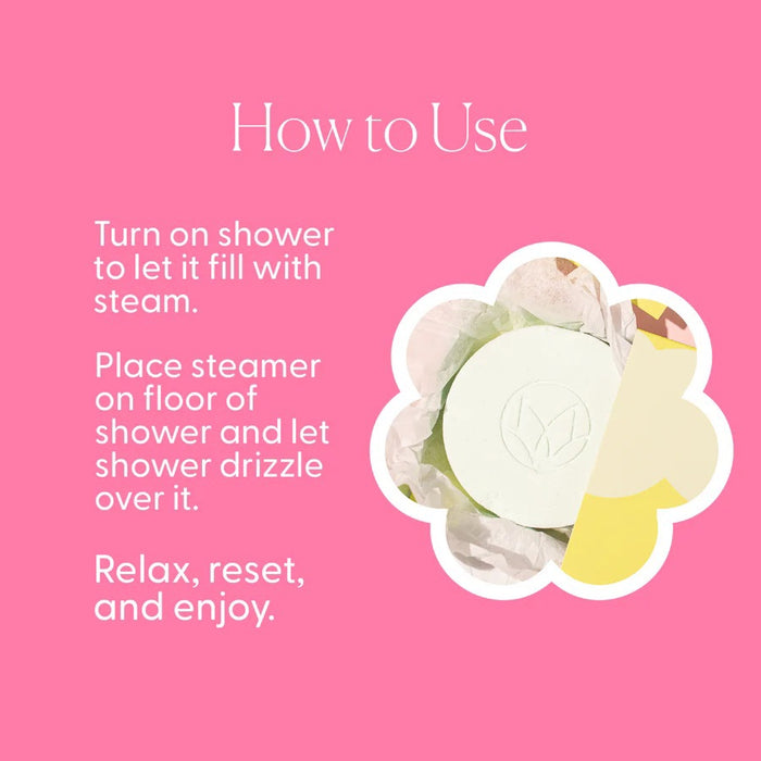 A pastel green packet labeled “MUSEE - EUCALYPTUS & MINT SHOWER STEAMERS” from MUSEE, featuring a shower icon, is displayed behind four round white shower steamers embossed with a leaf design—offering a spa-like experience with these natural bath products.