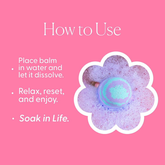A light green MUSEE - TAKE IT EASY BATH BALM by MUSEE sits on a white plate next to a decorative plant atop a wooden tray, highlighting the artisanal appeal of handcrafted bath products.