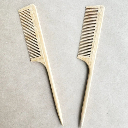 Two wooden combs on a light gray background