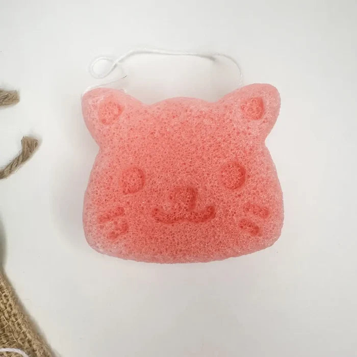 Pink cat-shaped sponge on a white background